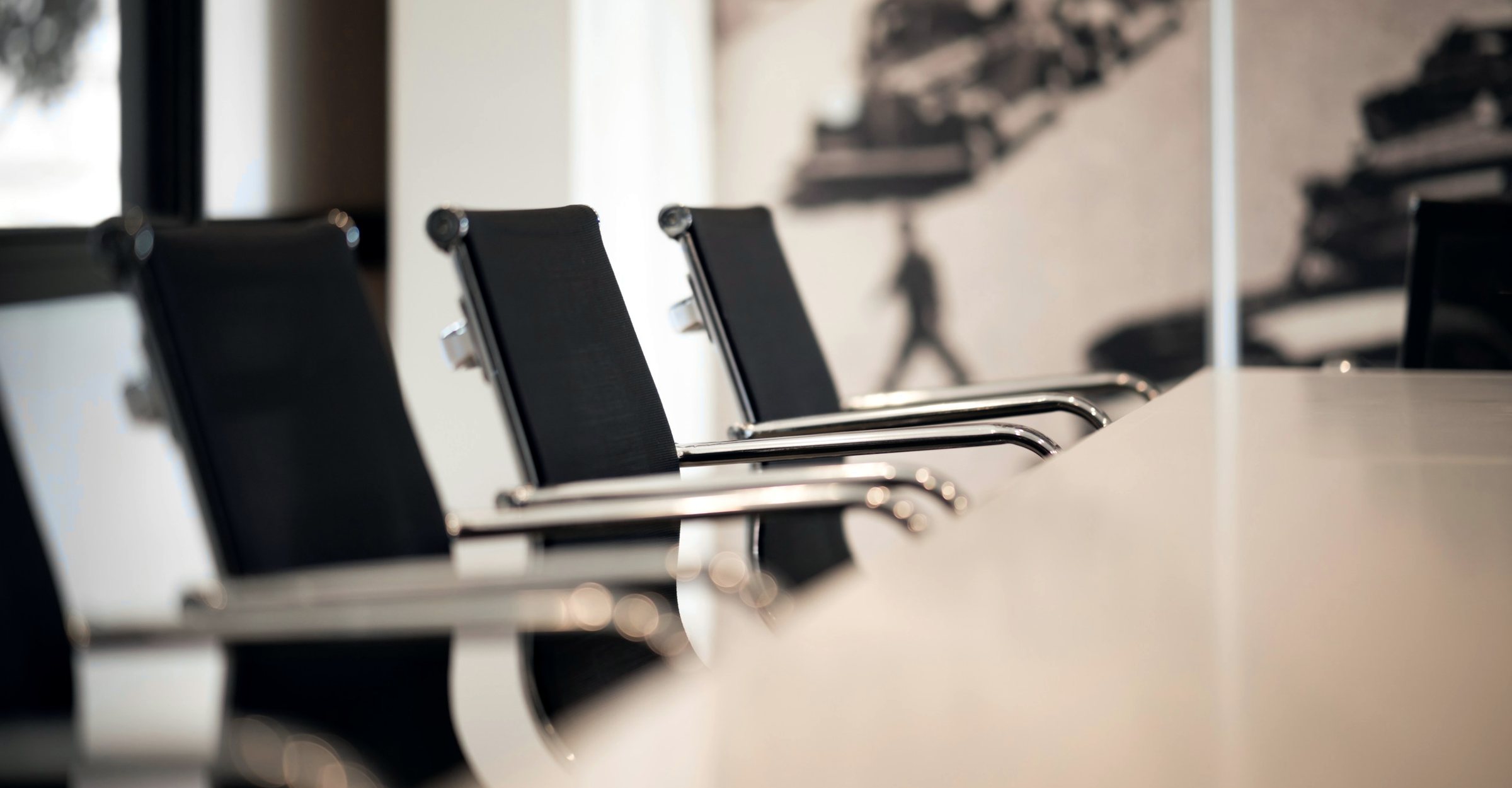 Black leather chairs along a conference table
