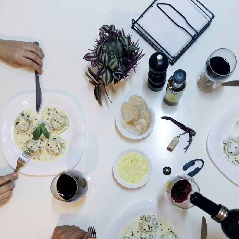 Friends sharing dinner and wine around a table